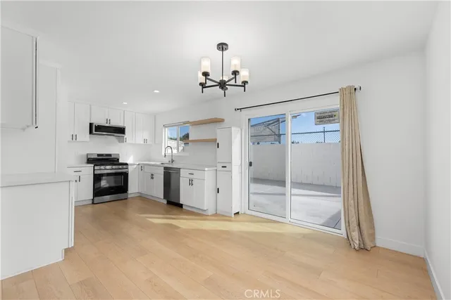 a view of a kitchen with a sink and stainless steel appliances