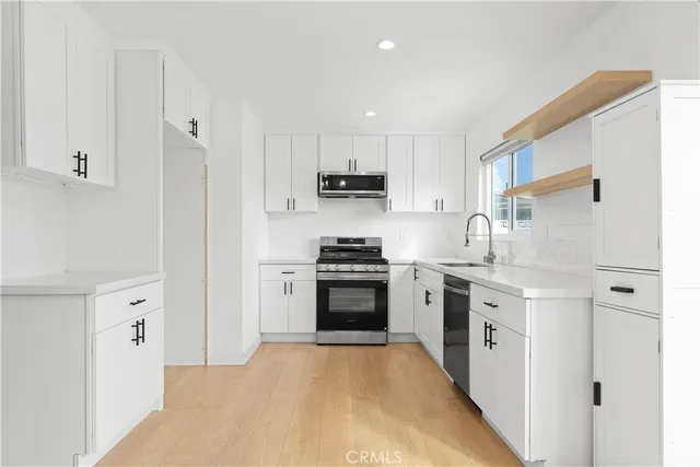 a kitchen with stainless steel appliances granite countertop a stove and a refrigerator