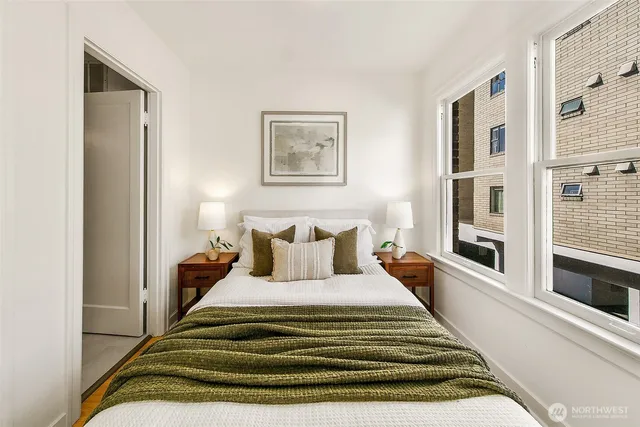 a bedroom with bed and night stand