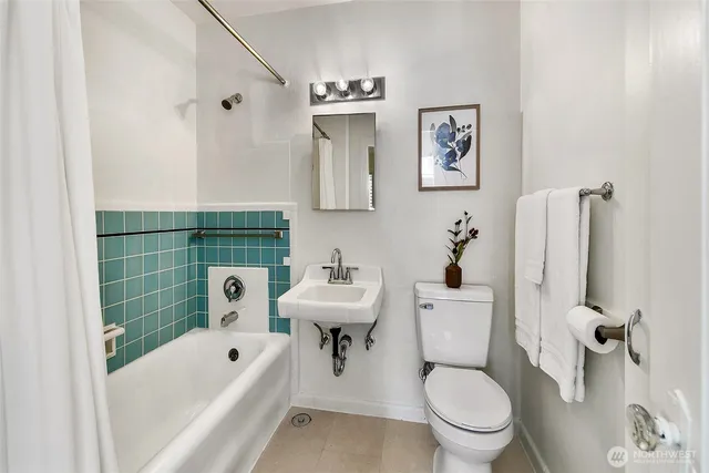 a bathroom with a sink toilet and bathtub