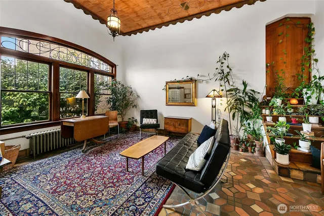 a living room with furniture and a potted plant
