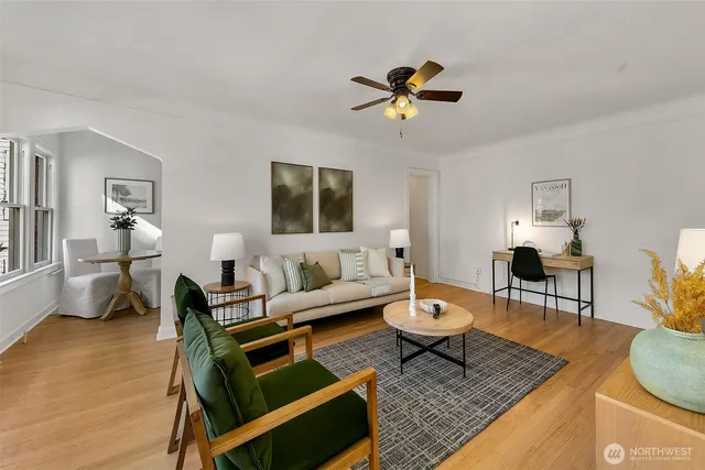 a living room with furniture a rug and a chandelier