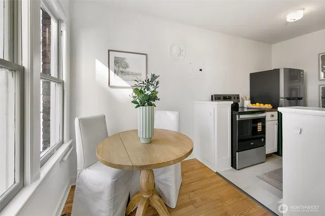 a dining room with furniture and a potted plant