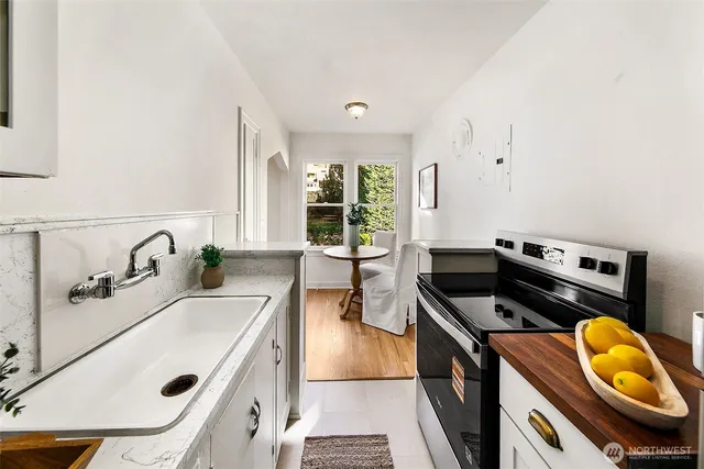 a kitchen that has a sink and a stove