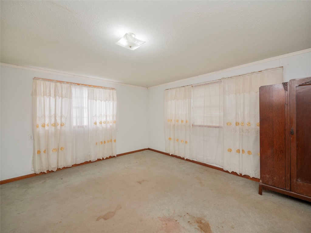 3104 South Main Street Taylor, TX 76574 - Photo 5 of 22 an empty room with a empty space and windows