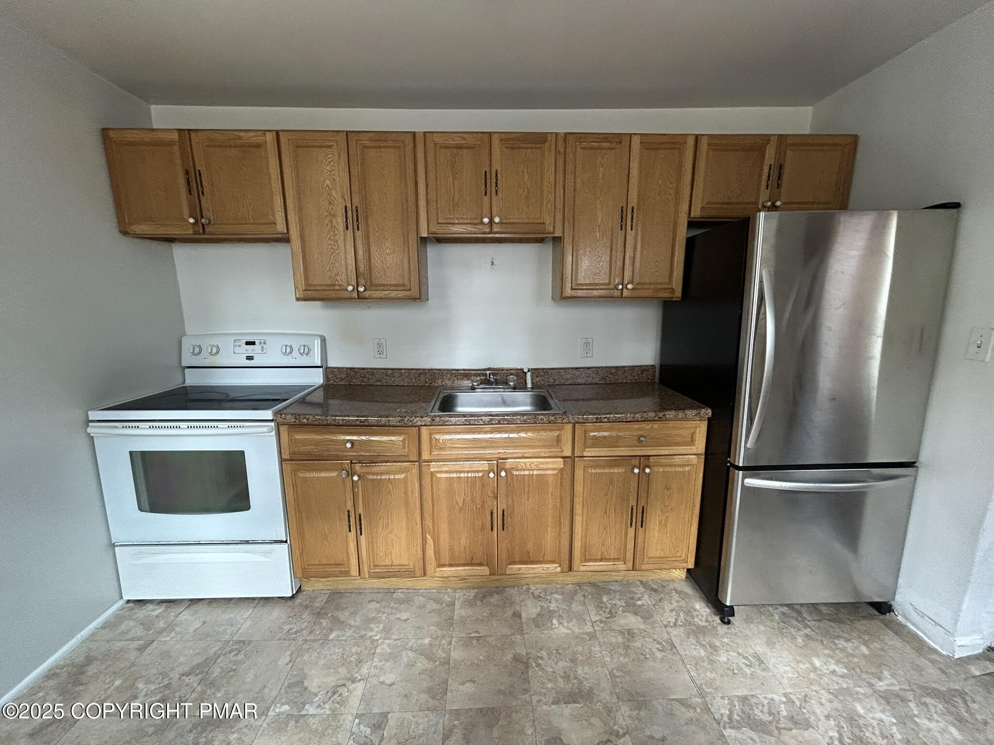 175 Prospect Street, Unit 1771 East Stroudsburg, PA 18301 - Photo 3 of 13 a kitchen with a refrigerator sink and cabinets