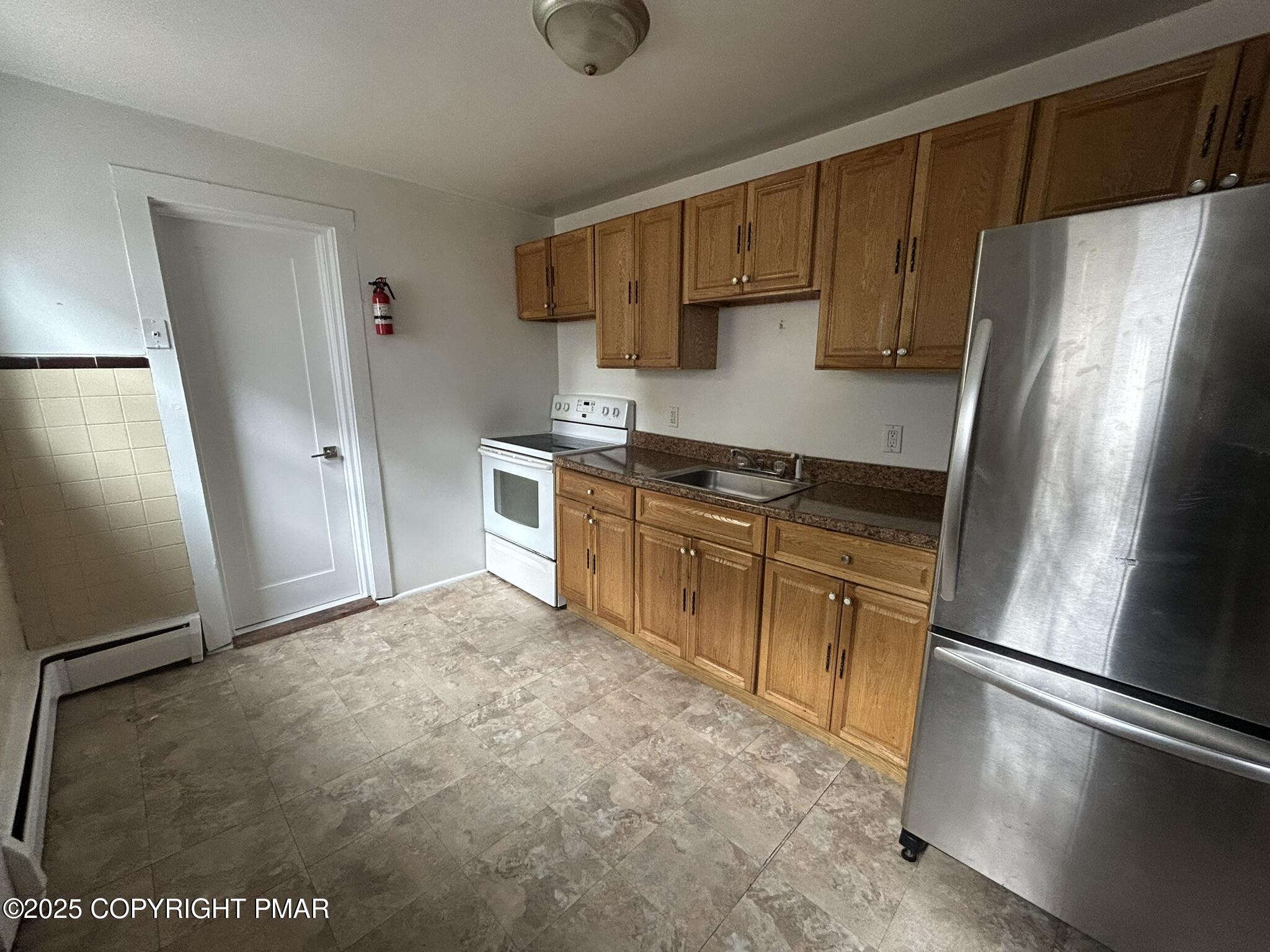 175 Prospect Street, Unit 1771 East Stroudsburg, PA 18301 - Photo 5 of 13 a kitchen with stainless steel appliances a refrigerator stove and sink