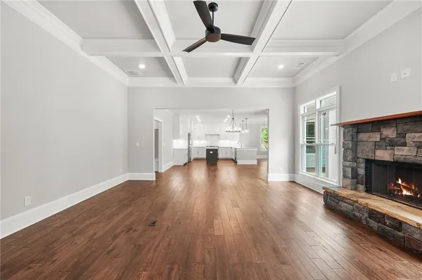 a living room with hardwood flooring and a fireplace