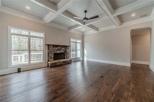 a kitchen with kitchen island granite countertop a stove a sink and a wooden floor