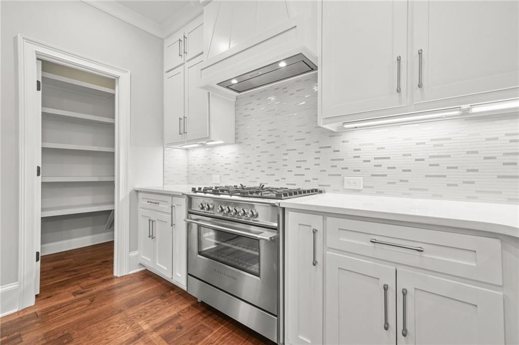 4720 Bold Springs Road Monroe, GA 30656 - Photo 21 of 83 a kitchen with granite countertop white cabinets and white appliances