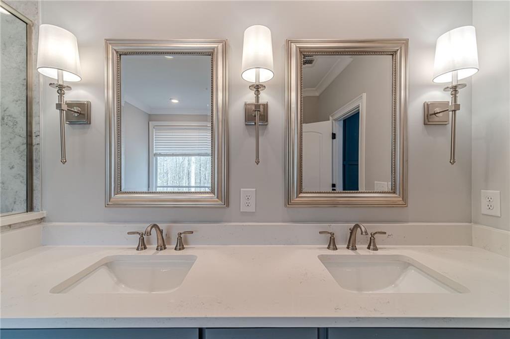 4720 Bold Springs Road Monroe, GA 30656 - Photo 37 of 83 a bathroom with double vanity sinks a vanity and a mirror