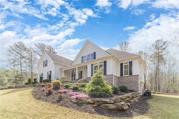 a view of dining room with wooden floor fire place and windows