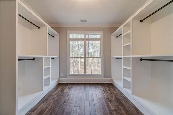 a view of a room with wooden floor and iron stairs