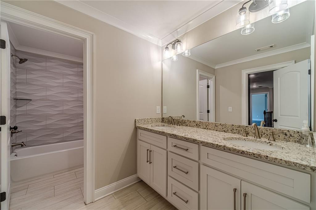 4720 Bold Springs Road Monroe, GA 30656 - Photo 50 of 83 a bathroom with a granite countertop sink a mirror and a