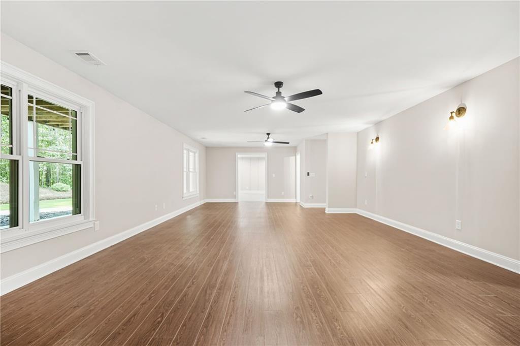 4720 Bold Springs Road Monroe, GA 30656 - Photo 54 of 83 a view of an empty room with wooden floor and a window