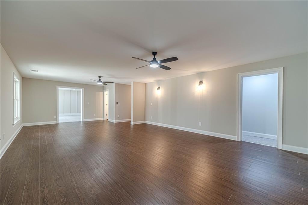 4720 Bold Springs Road Monroe, GA 30656 - Photo 55 of 83 a view of an empty room with wooden floor and a ceiling fan