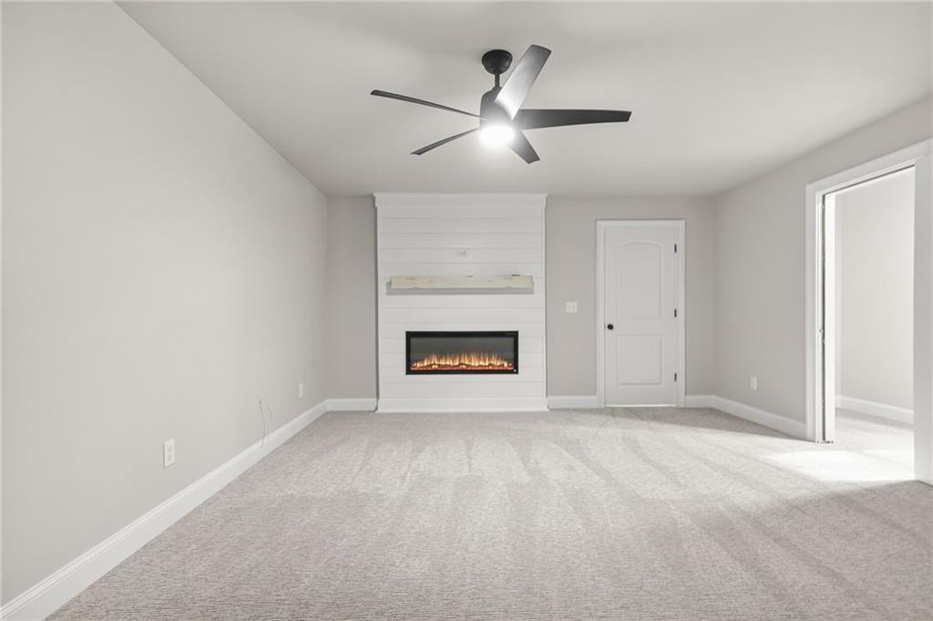 4720 Bold Springs Road Monroe, GA 30656 - Photo 56 of 83 an empty room with chandelier fan and windows