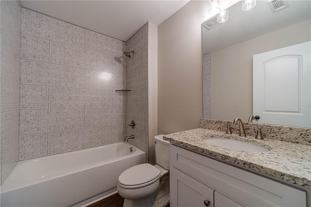 4720 Bold Springs Road Monroe, GA 30656 - Photo 62 of 83 a bathroom with a granite countertop bathtub shower sink vanity mirror and toilet