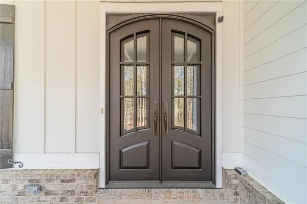 a kitchen with stainless steel appliances kitchen island granite countertop wooden floors and white cabinets