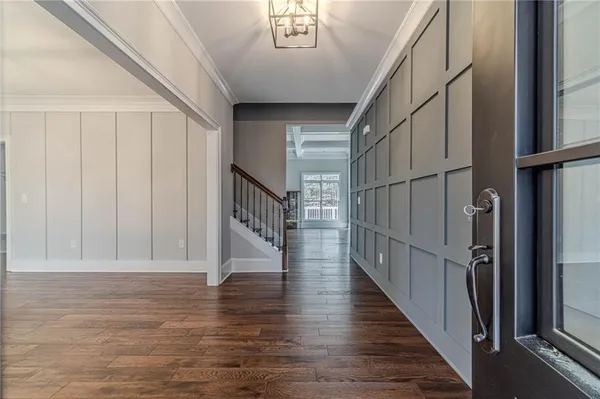 a large kitchen with granite countertop a large counter top a sink stainless steel appliances and cabinets