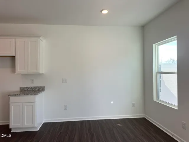 a view of kitchen with wooden floor and electronic appliances