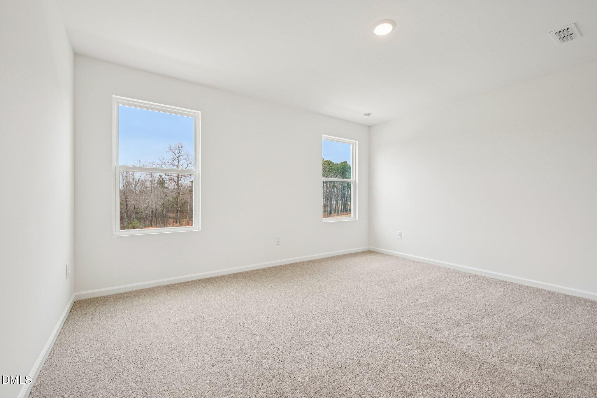 1522 Mirth Court Rolesville, NC 27571 - Photo 17 of 34 an empty room with windows