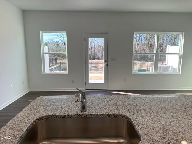 a view of a sink and a granite top oven