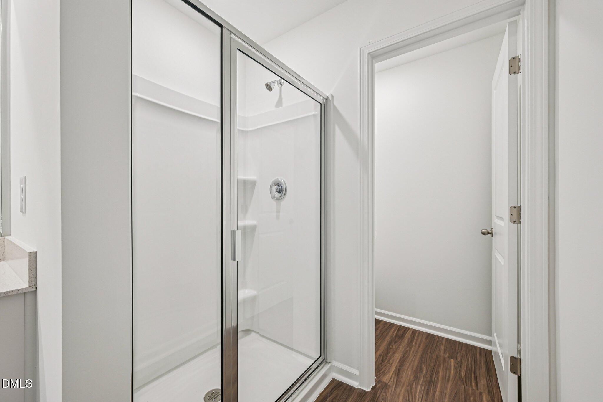 1522 Mirth Court Rolesville, NC 27571 - Photo 20 of 34 a bathroom with a glass shower door