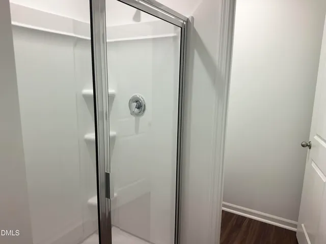 a bathroom with a glass shower door