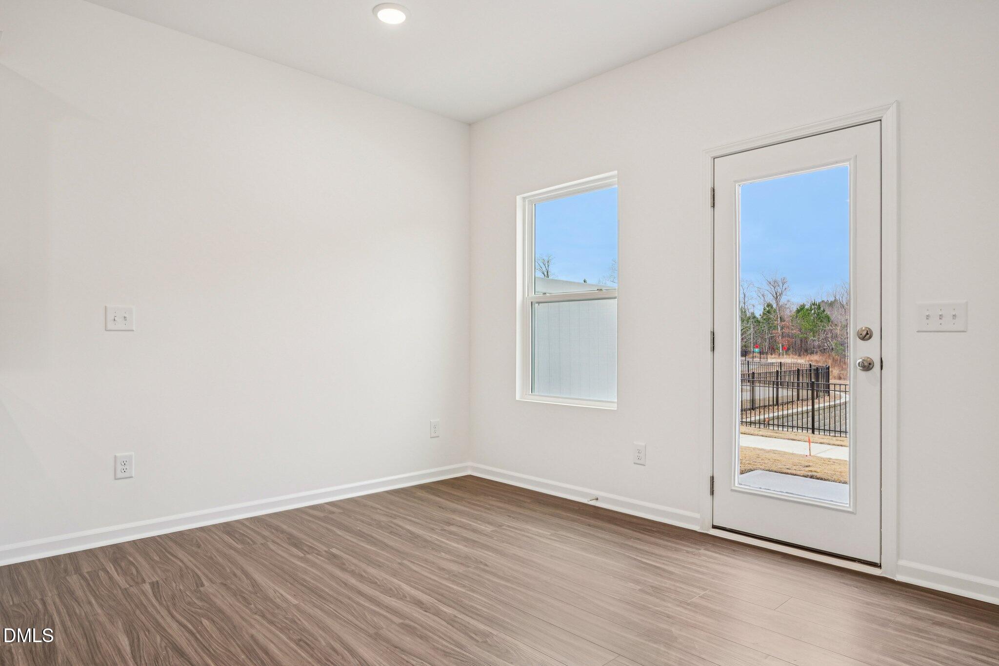 1522 Mirth Court Rolesville, NC 27571 - Photo 3 of 34 an empty room with wooden floor and windows