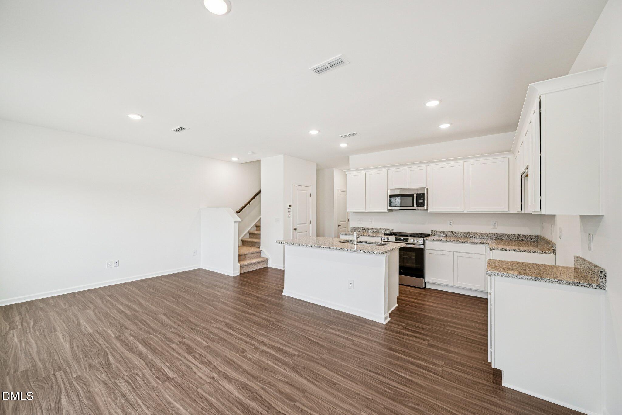 1522 Mirth Court Rolesville, NC 27571 - Photo 5 of 34 a kitchen with a refrigerator and a stove top oven