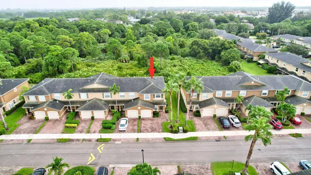 an aerial view of multiple houses with a yard