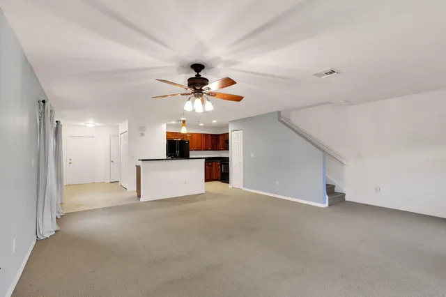 a view of an empty room with a ceiling fan