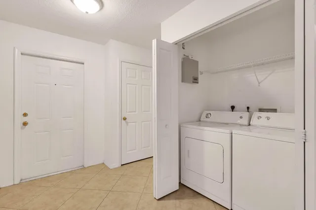 a utility room with cabinets washer and dryer