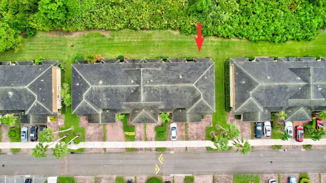an aerial view of a house with a yard basket ball court and outdoor seating