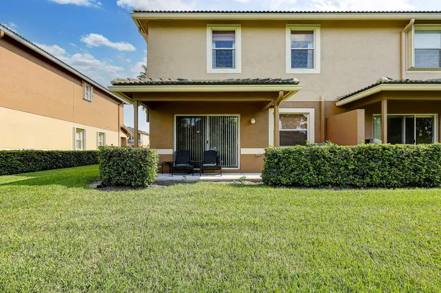a view of a house with backyard porch and garden