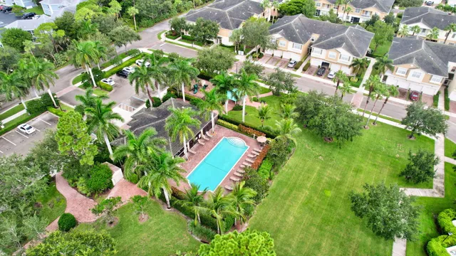 an aerial view of residential houses with outdoor space and trees