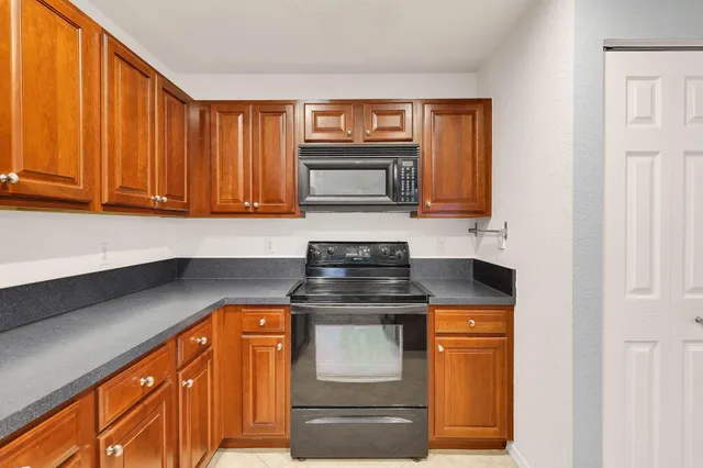 a kitchen with stainless steel appliances granite countertop a stove and a microwave