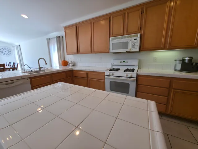 a view of a dining room and livingroom with furniture a rug a rug and a window