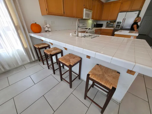 a bedroom with bed and flowerpot