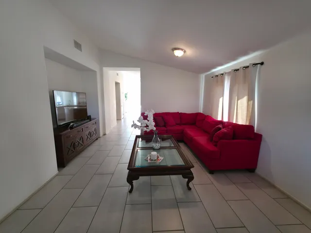 a kitchen with stainless steel appliances a sink a stove a microwave a counter top space and cabinets