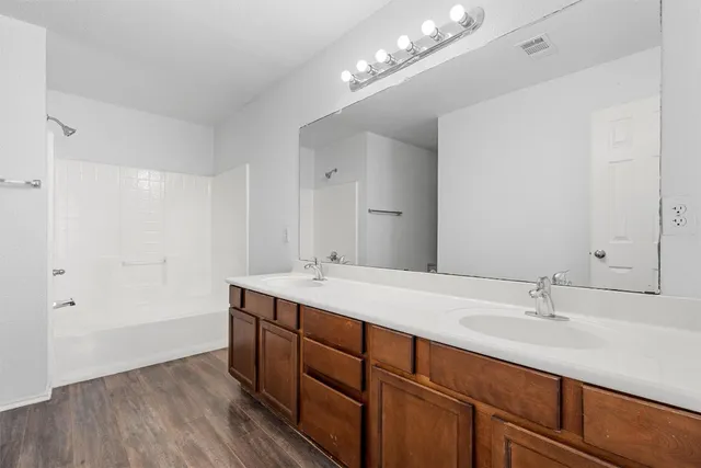 a bathroom with a sink double vanity and a mirror