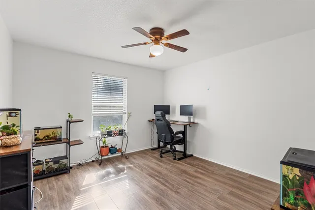 a view of a workspace with furniture and a window