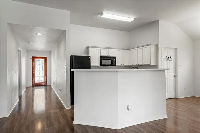 a kitchen with stainless steel appliances a refrigerator sink and microwave
