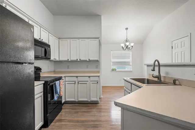 a kitchen with stainless steel appliances a sink stove and cabinets