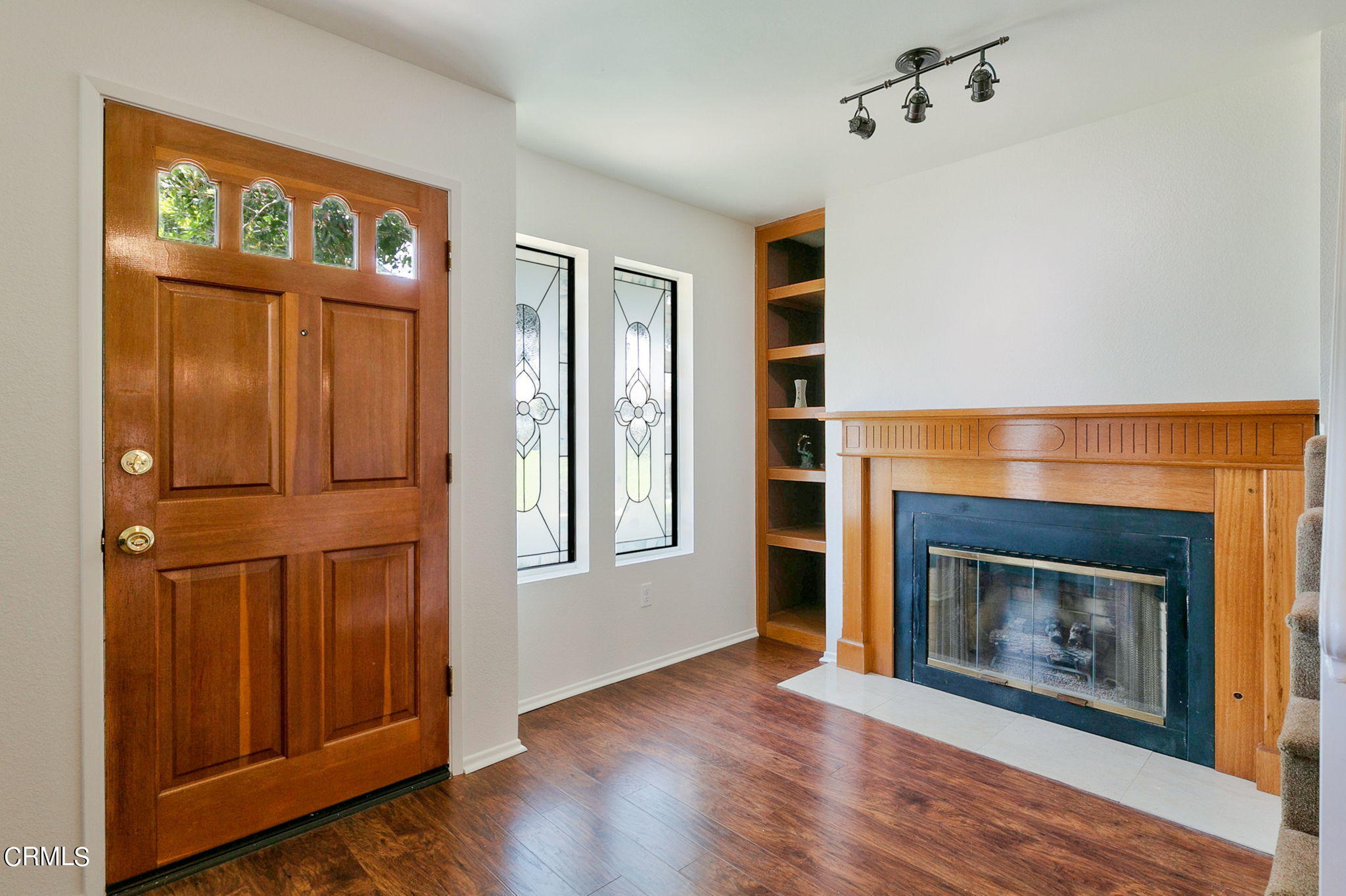 3524 Olds Road Oxnard, CA 93033 - Photo 5 of 43 an empty room with wooden floor fireplace and windows