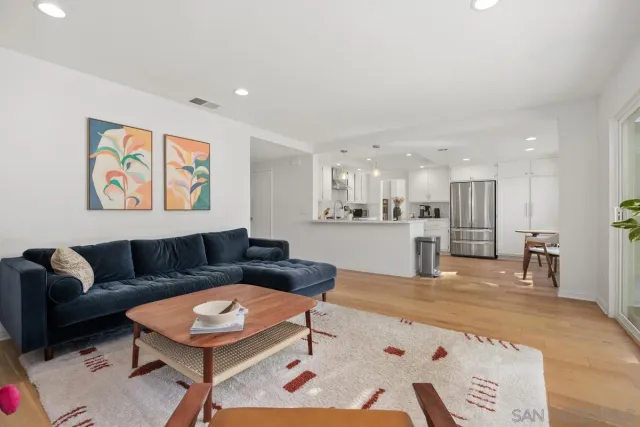 a living room with furniture and kitchen view