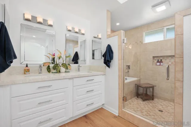 a bathroom with a shower sink and mirror