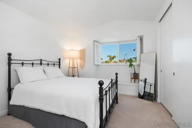 a bedroom with a bed and a lamp