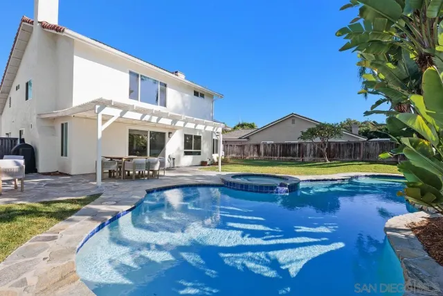 a view of a swimming pool with sitting area